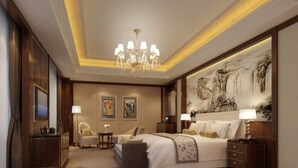 A spacious bedroom with a large bed, a chandelier, a painting on the wall, and a desk with a lamp. - Ningxia Xigang Airlines Hotel (Yinchuan)