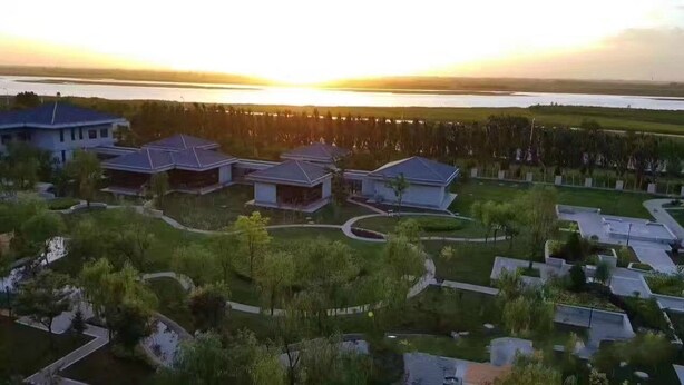 A residential area with modern houses, a large body of water, and a sunset. - Ningxia Xigang Airlines Hotel (Yinchuan)