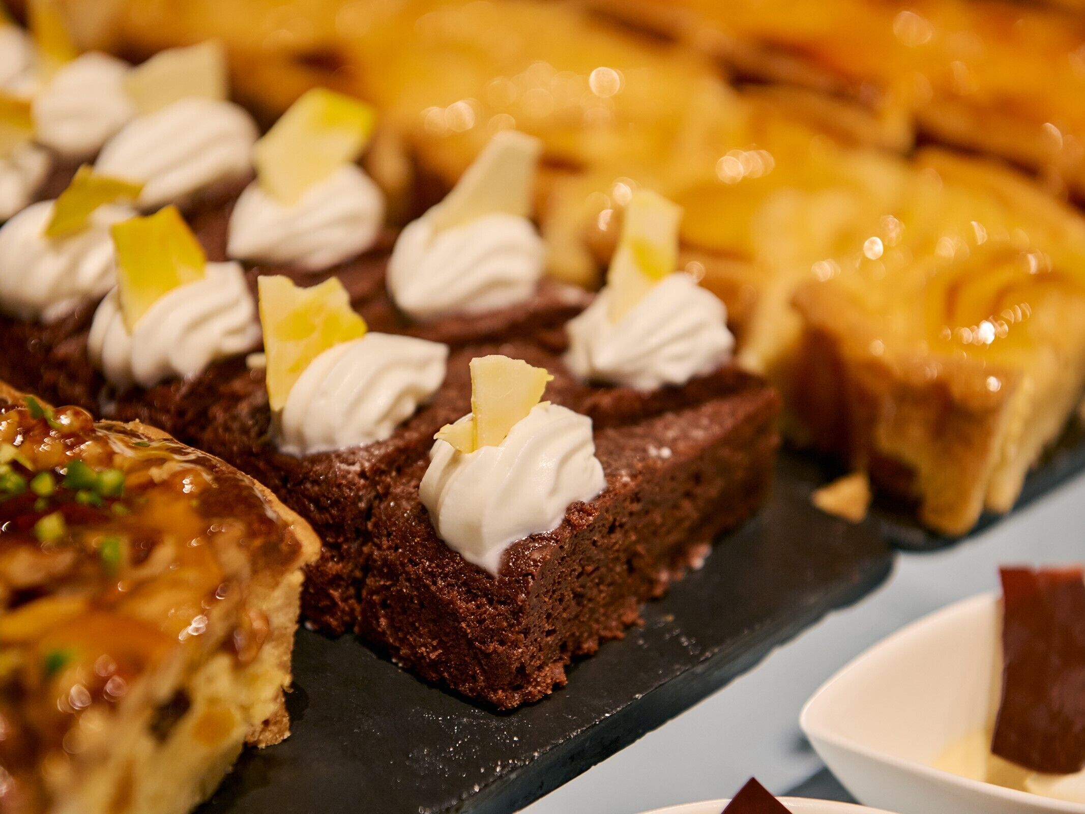 A variety of desserts on a slate serving board.