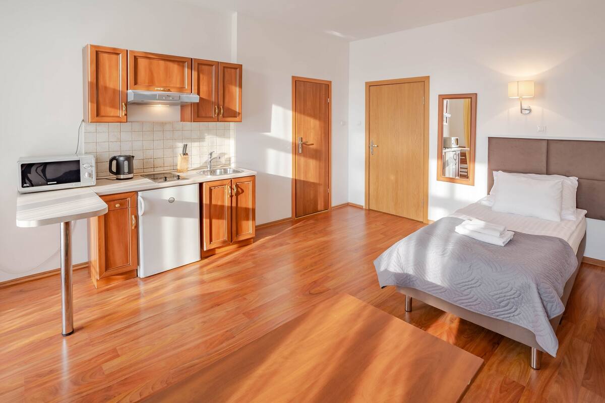 classic quadruple room | living area | flat-screen tv