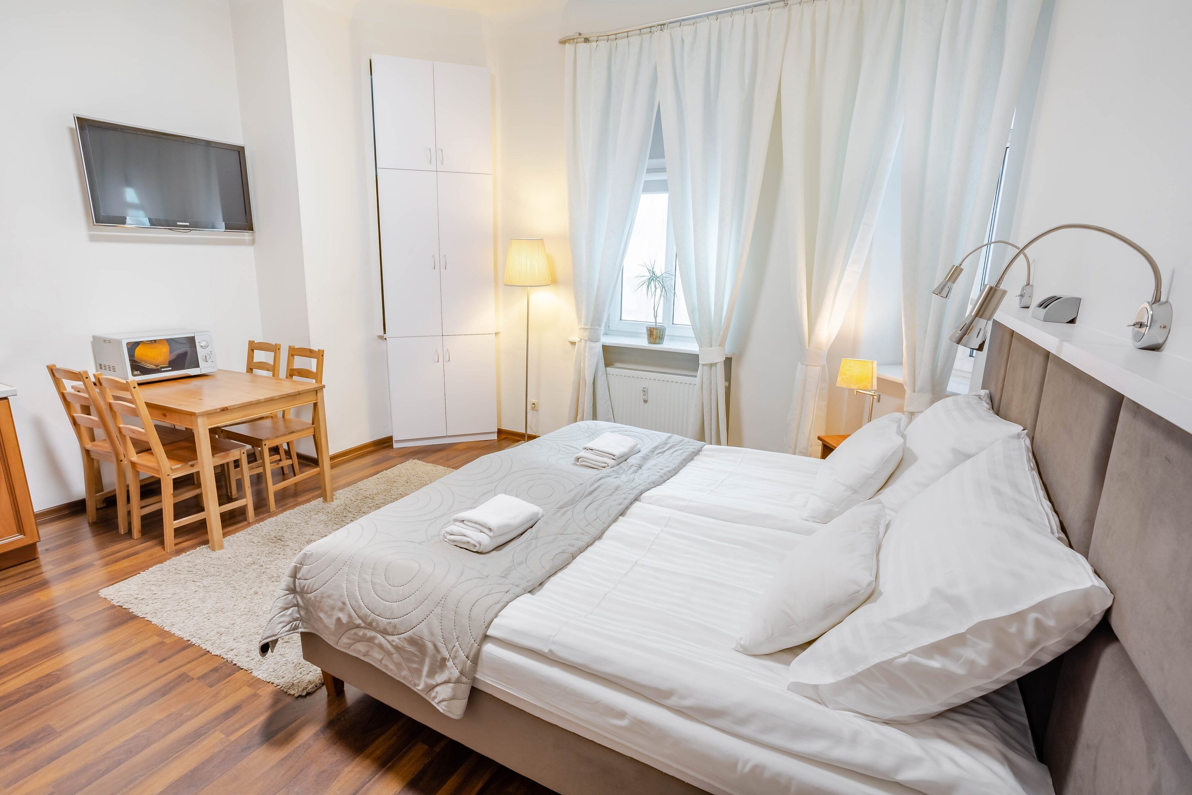 classic quadruple room | living area | flat-screen tv