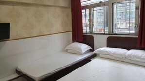 A single-bed room with a window, a TV mounted on the wall, and a patterned wallpaper. - Lung Wa Hotel (Kowloon)