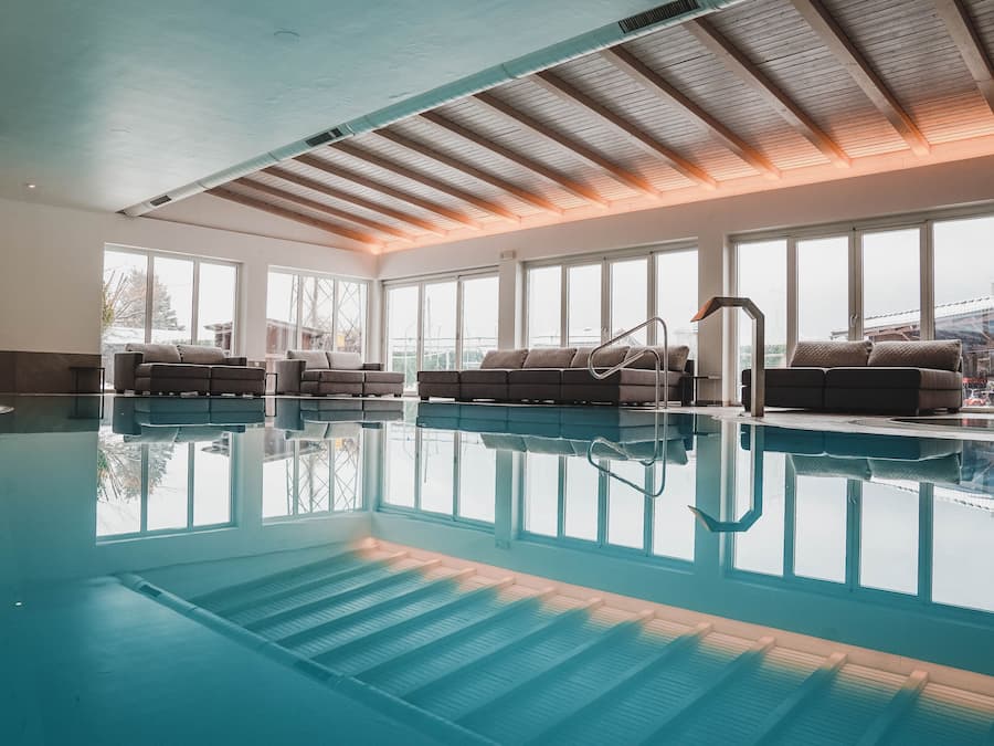 Indoor pool, open 9:00 AM to 9:00 PM, pool umbrellas, pool loungers