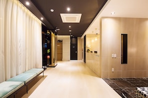 Welcome to our lobby, featuring a long reception desk, comfortable seating, and a well-lit atmosphere.