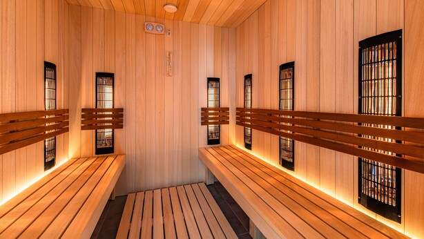 A sauna with wooden benches and black-framed windows. - Hotel La Mar (Kielce)