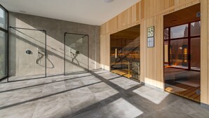 A modern interior with a glass partition, wooden panel walls, and a staircase leading to an upper level. - Hotel La Mar (Kielce)