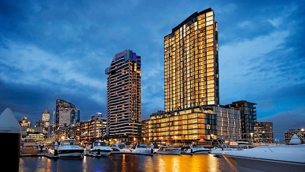 A waterfront cityscape with modern high-rise buildings, a marina with boats, and a clear sky. - Melbourne Docklands Concavo Seaview Apartment (Docklands)