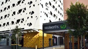 A Woolworths store with a distinctive exterior featuring a patterned facade and a large, modern sign. - Melbourne Docklands Convesso Seaview Apartment (Docklands)