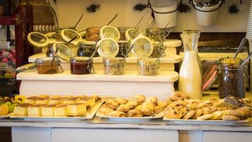 A buffet with various food items and condiments.