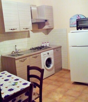 Apartment, 1 Bedroom | Private kitchenette | Full-size fridge, oven, stovetop, cookware/dishes/utensils