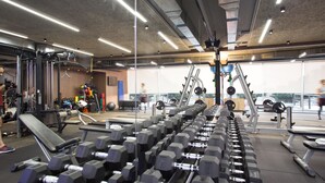 A gym with various exercise equipment, including dumbbells and treadmills. - The Stay Furnished Apartments (Dbayeh)