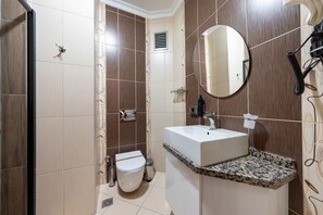 A bathroom with a white sink, a mirror, and a toilet. - 216 Macity  (Istanbul)