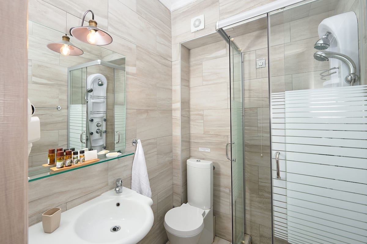 family suite, sea view | bathroom | shower, designer toiletries, hair dryer, slippers
