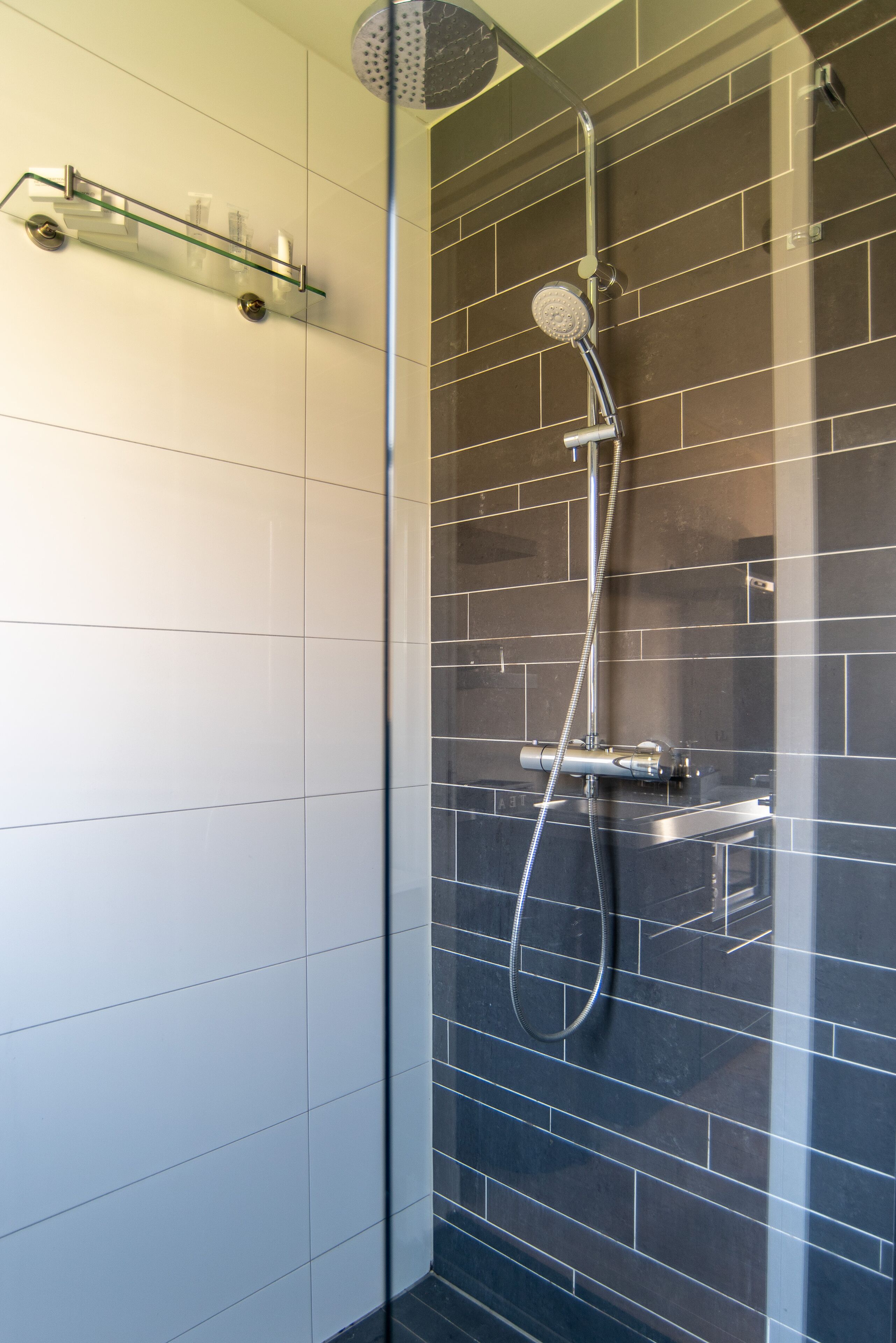 studio, 1 king bed with sofa bed, kitchenette, lake view | bathroom | shower, rainfall showerhead, hair dryer, towels