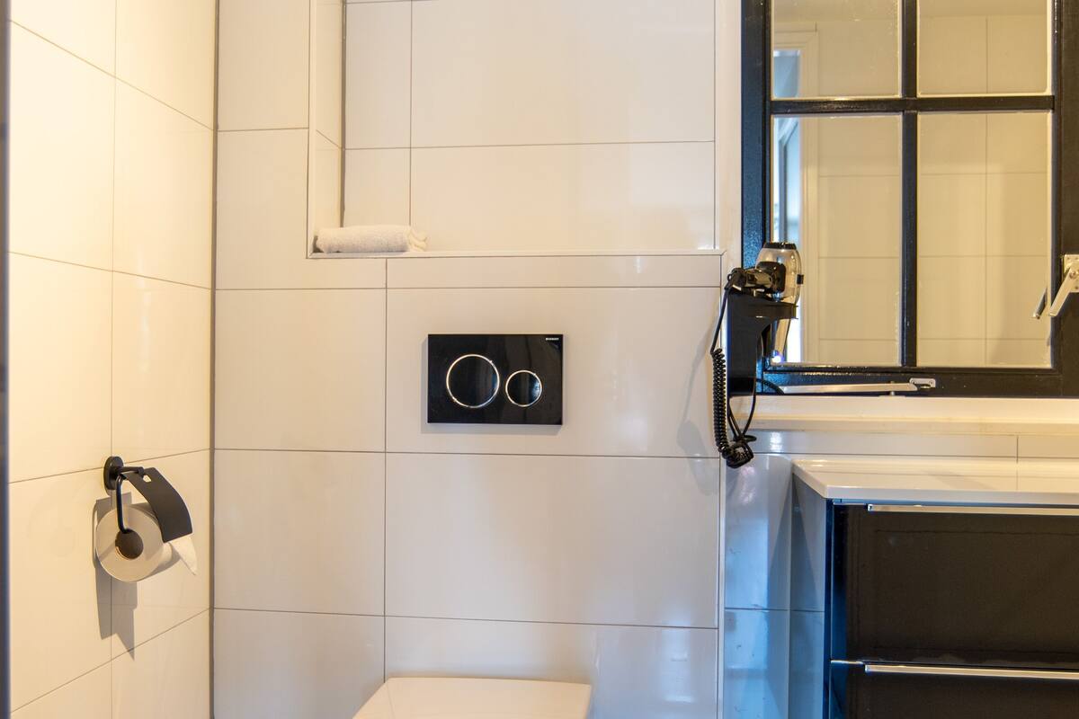 deluxe studio | bathroom | shower, rainfall showerhead, hair dryer, towels