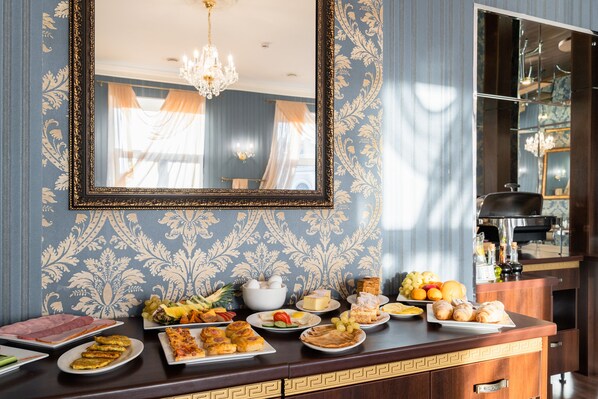 Experience refined comfort in this elegantly designed room, featuring a spacious seating area and a well-appointed kitchenette.