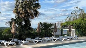 Seasonal outdoor pool, open 10:00 AM to 9:00 PM, pool loungers