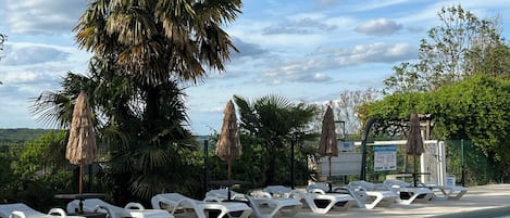 Seasonal outdoor pool, open 10:00 AM to 9:00 PM, pool loungers