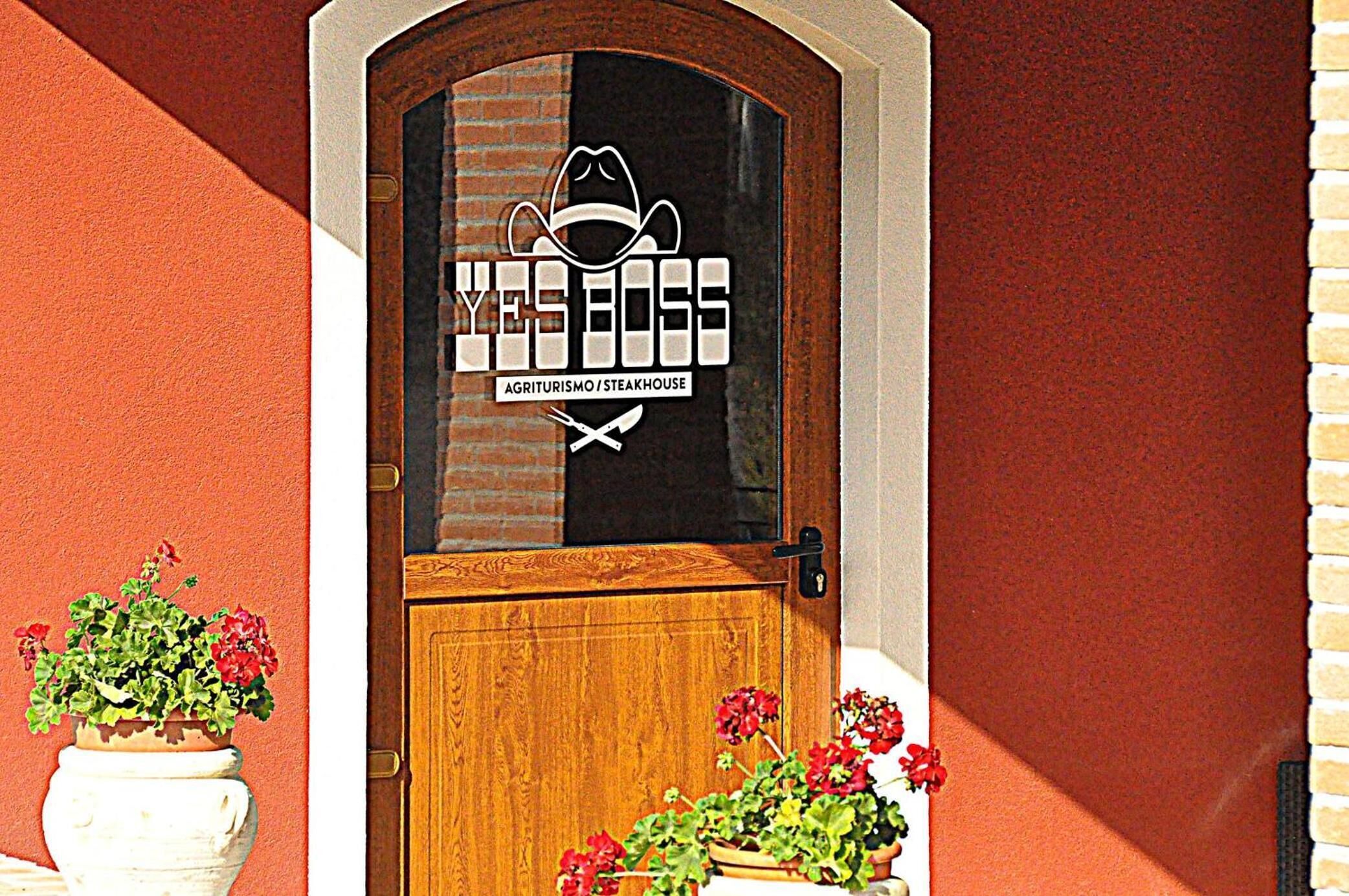A wooden door with a glass window featuring a logo and text.