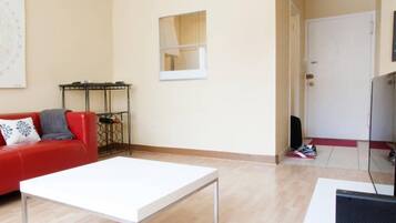City Apartment, 1 Bedroom | Living room | Flat-screen TV, pay films