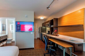 A hotel room with a bed, a desk with a computer, a TV, a microwave, and a refrigerator. - TownePlace Suites by Marriott Lexington Keeneland/Airport (Lexington)