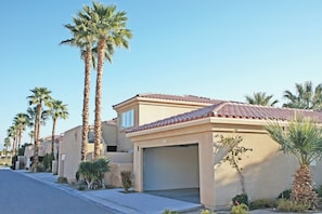 A residential street with houses featuring red-tiled roofs and palm trees. - Worldmark Cathedral City (Cathedral City)