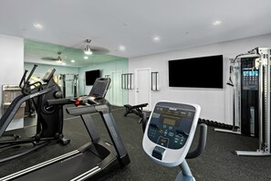 A modern gym with a treadmill, exercise bike, and weight machines. - Worldmark Cathedral City (Cathedral City)