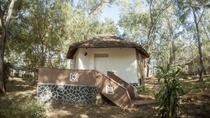 A small, single-story building with a tiled roof, surrounded by trees and a garden. - Apsaras Resort Sigiriya (Sigiriya)