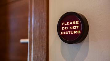 A wall-mounted sign with the text "PLEASE DO NOT DISTURB" in a circular frame.