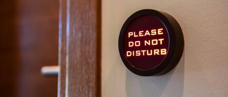 A wall-mounted sign with the text "PLEASE DO NOT DISTURB" in a circular frame.