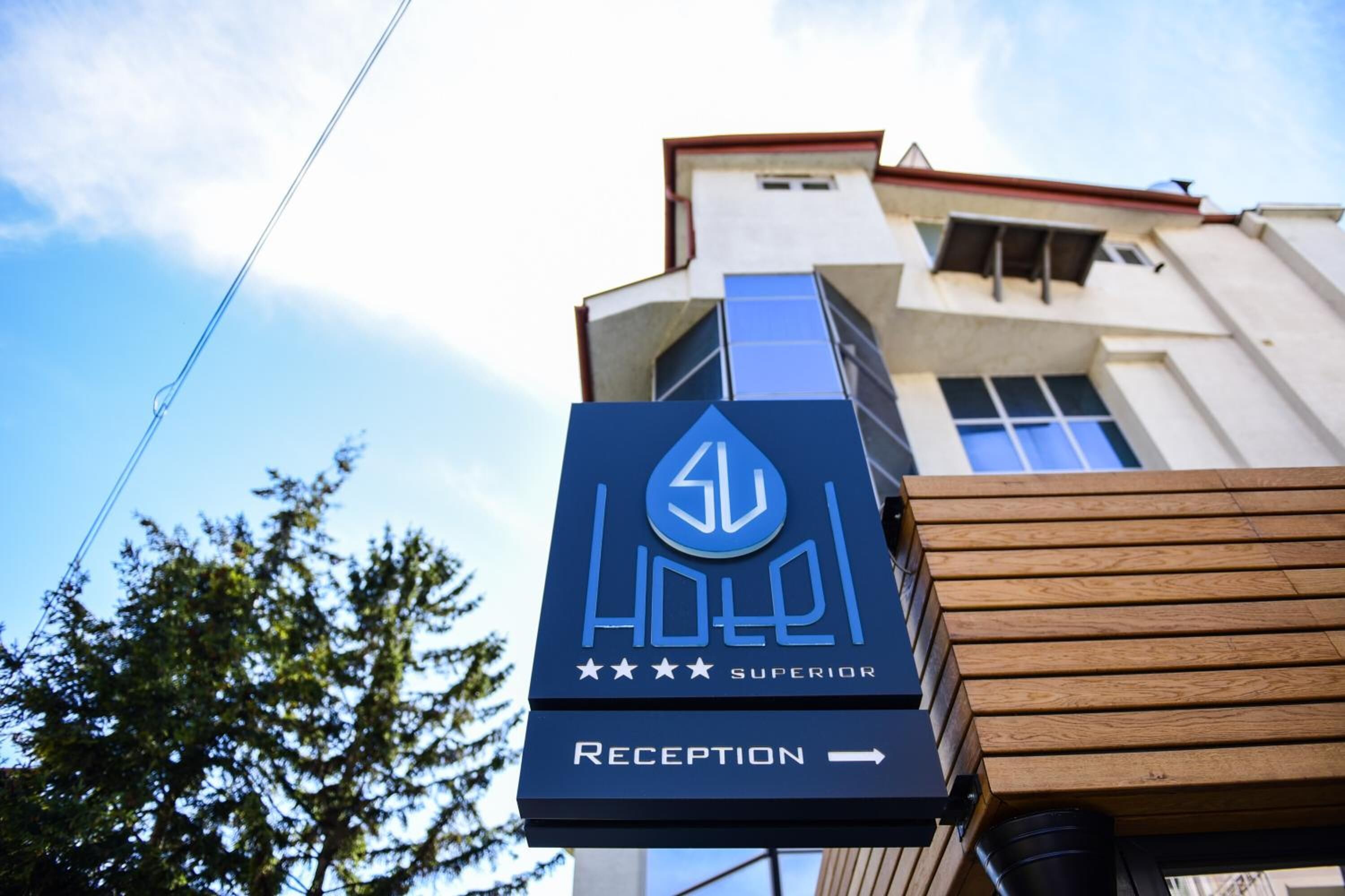A hotel sign with a reception direction.