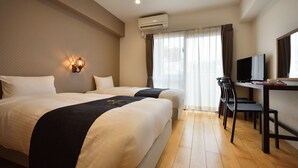 A hotel room with two beds, a desk with a television, and a chair. - TOKI NO YADO NAHA by SUNREST RESORT (Naha)