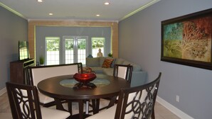 A dining area with a round table, chairs, and a ceiling fan. - Beautiful 2/2 Apartment in Lake Conroe • Sleeps 6 (Montgomery)