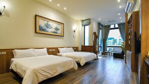 A hotel room with two beds, a painting on the wall, a TV, and a view of the city through the window. - Chien Ching B&B (New Taipei City)