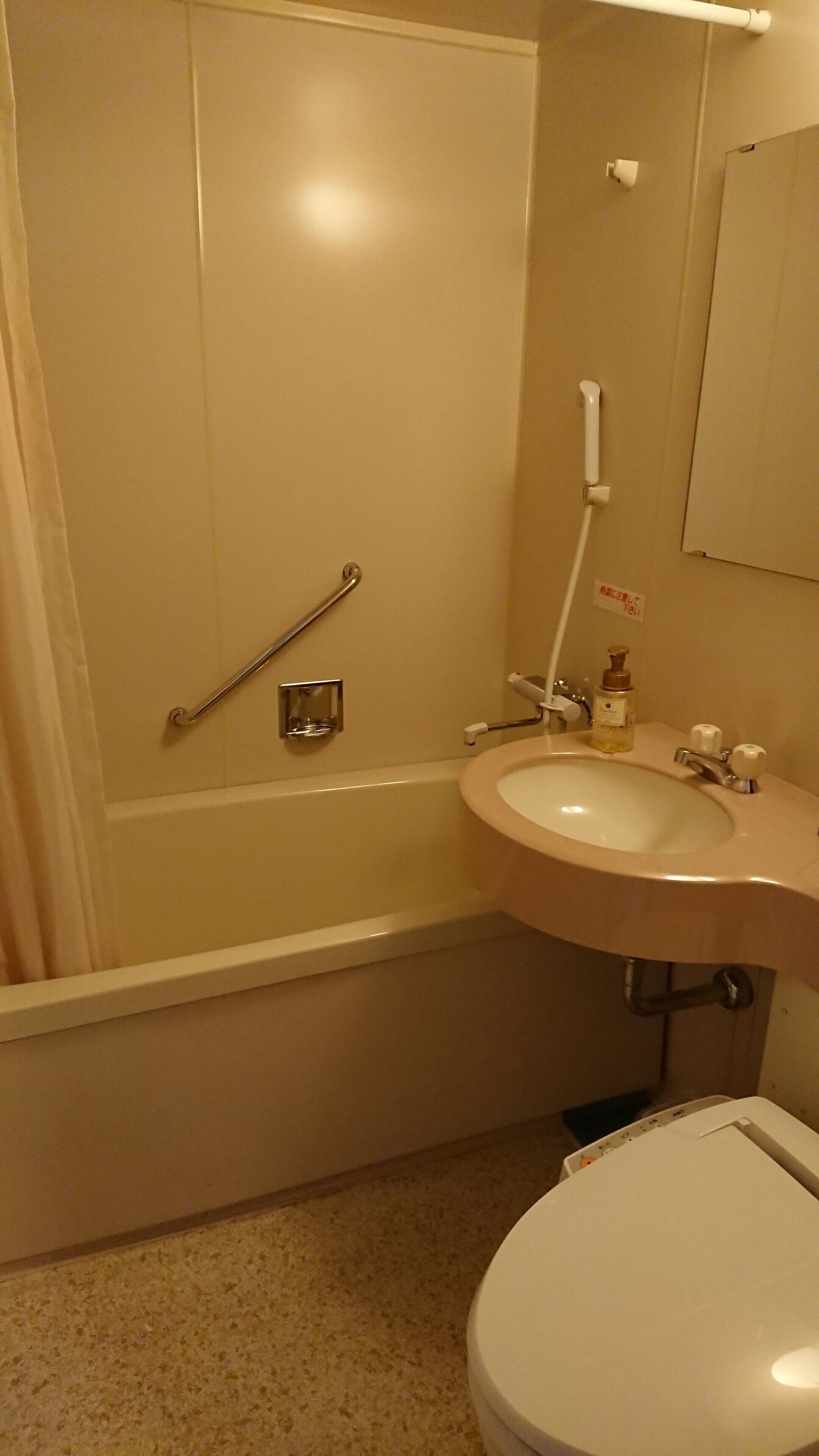 A bathroom with a bathtub, a sink, and a toilet.