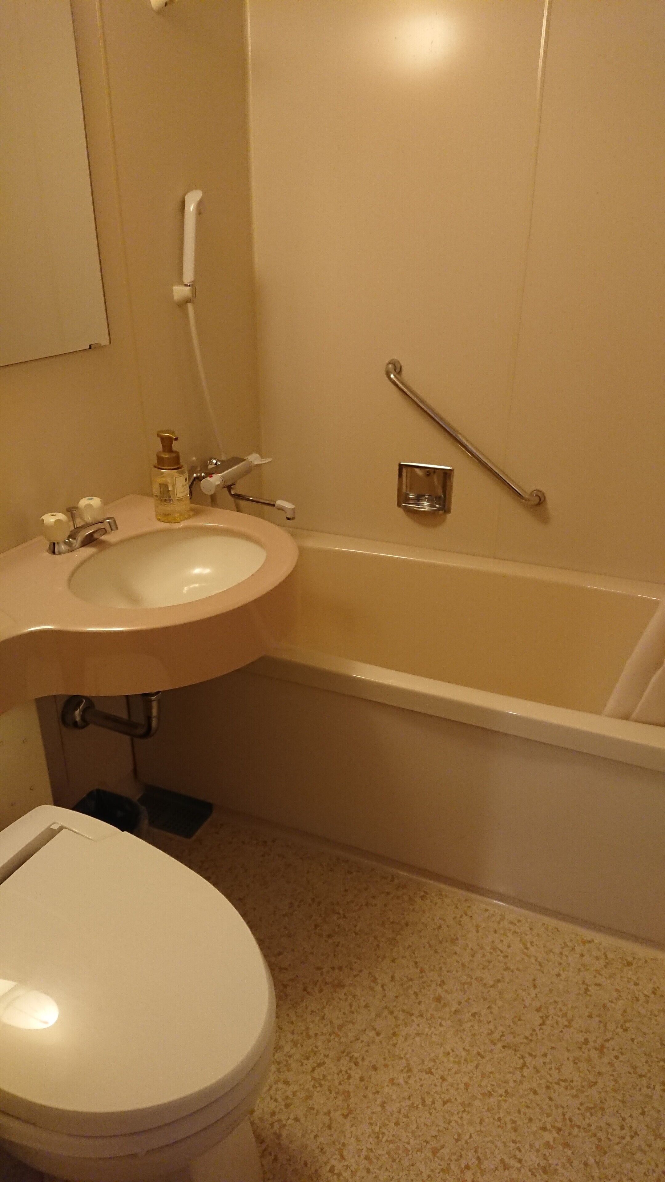 A bathroom with a sink, toilet, and bathtub.