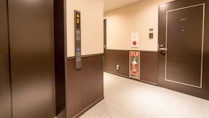 An elevator with a digital display, a fire extinguisher, and a door with the number 301. - Le Studio Gojo Takakura (Kyoto)