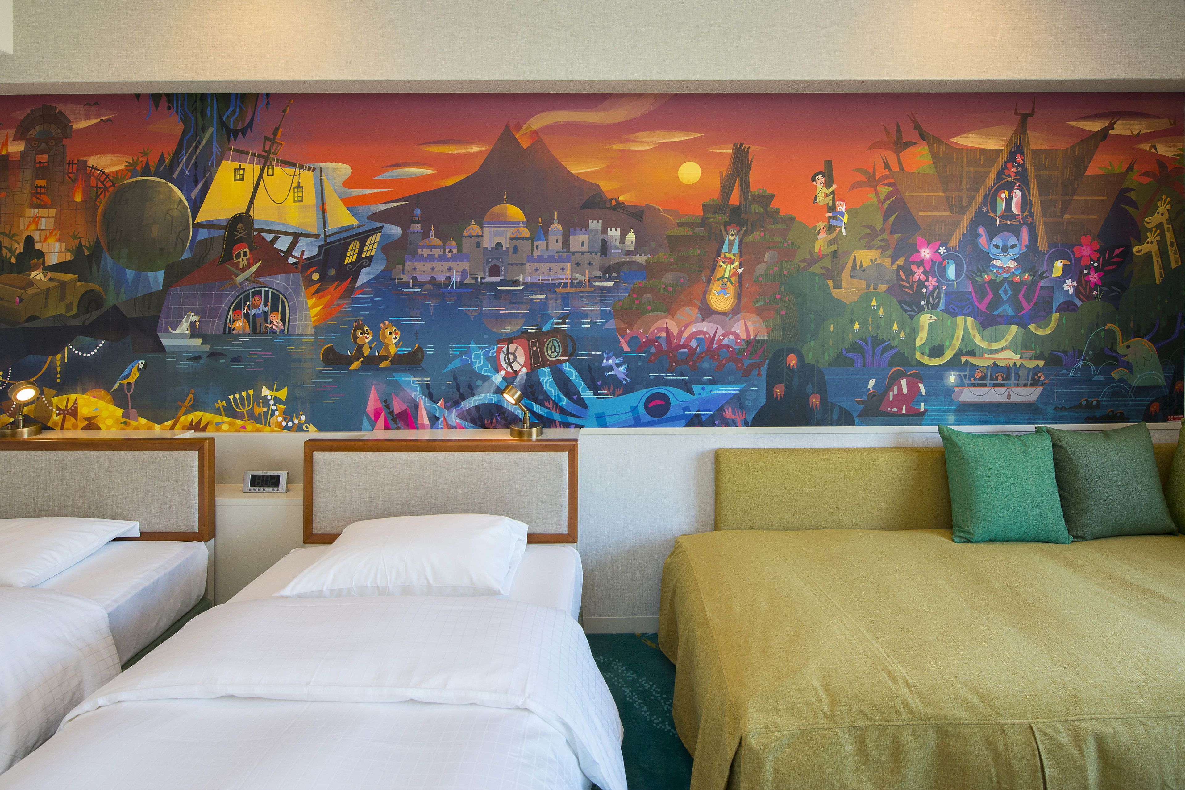 A hotel room with two beds, a green sofa, and a colorful mural depicting a tropical scene.