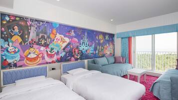 A hotel room with three beds, a large mural, and a balcony with a view.