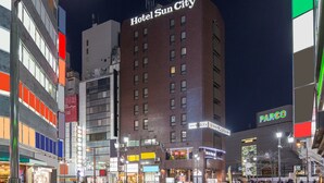 A multi-story building with a prominent sign reading "Hotel Sun City."