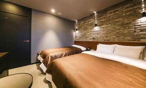 A hotel room with two beds, a dark-colored wardrobe, a brick accent wall, and recessed ceiling lighting. - A-VANT HOTEL (Cheonan)
