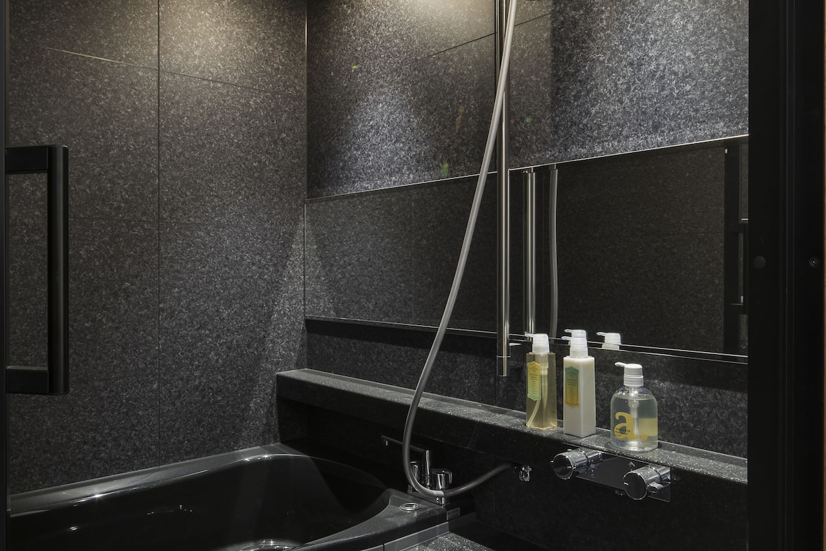 designer toiletries, hair dryer, slippers, bidet