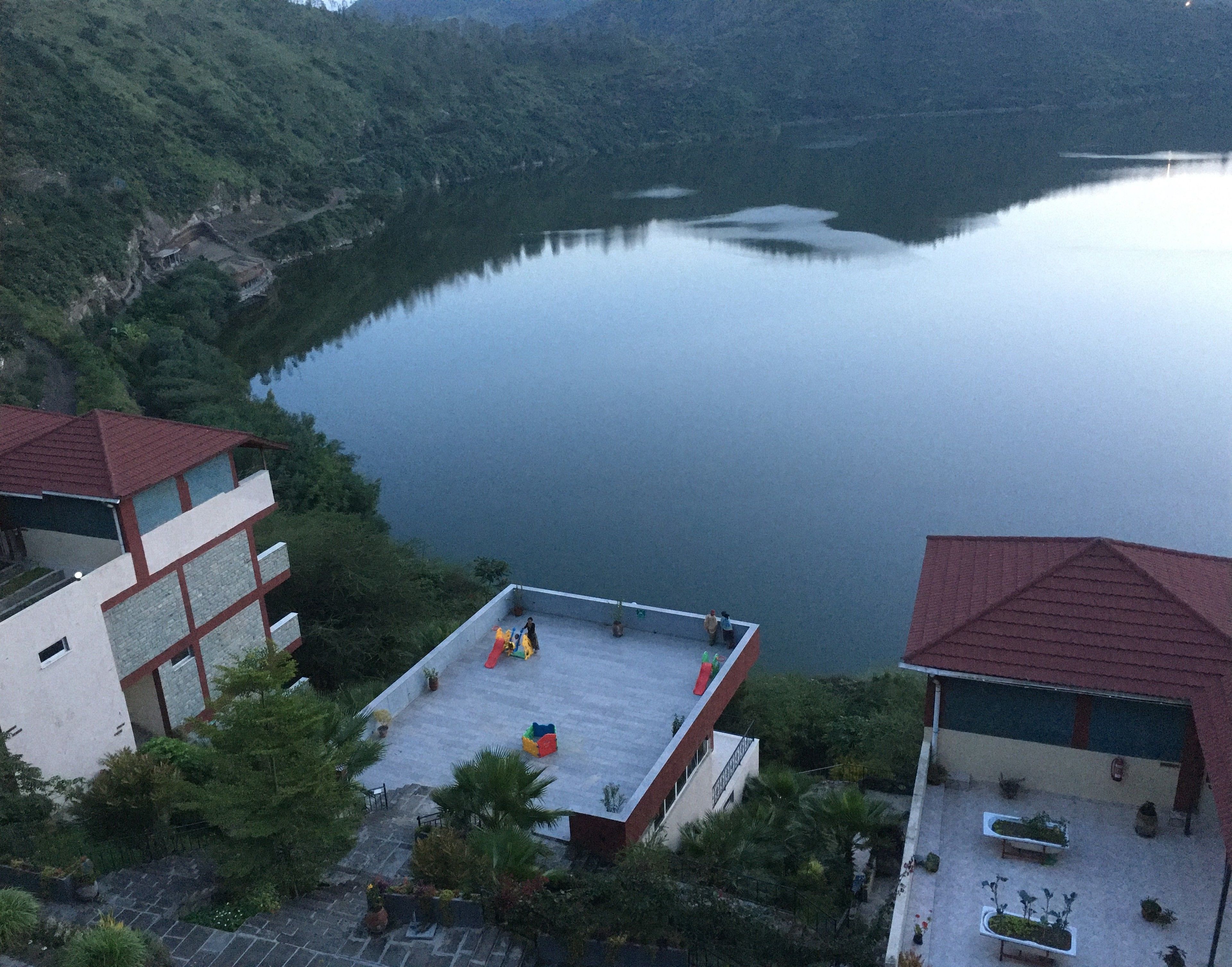 A view of a lake with a building in the foreground.