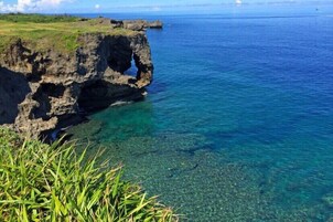 Un paisaje costero con aguas azules cristalinas y acantilados rocosos.
