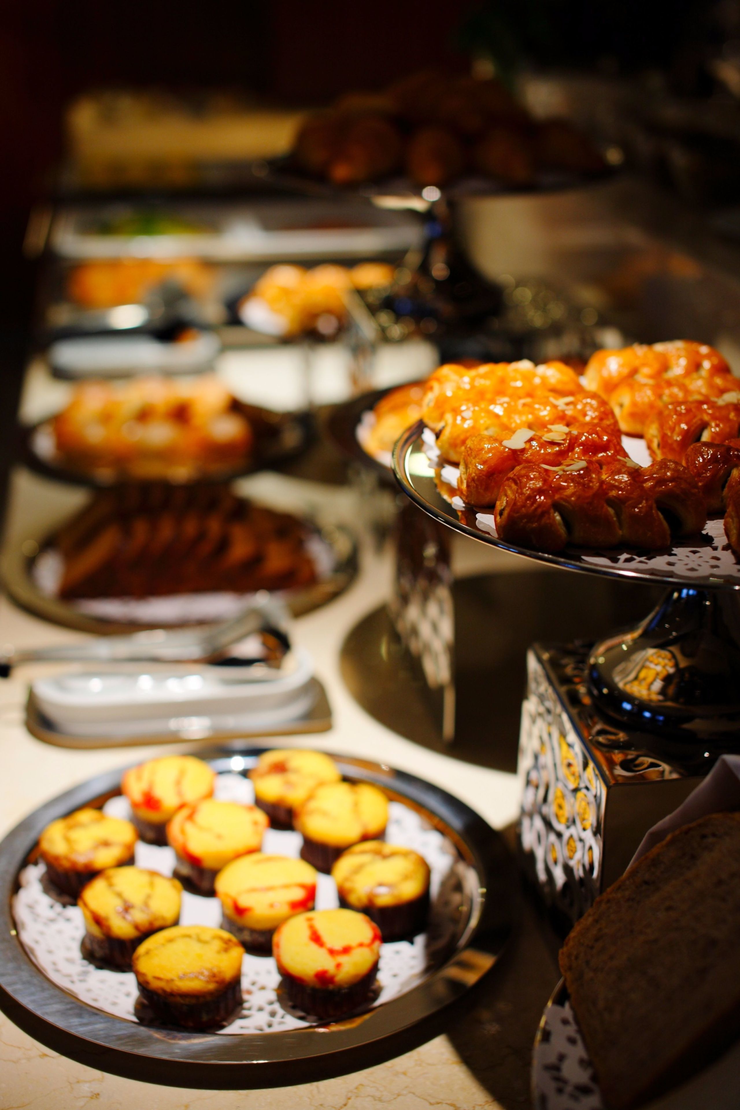 A buffet with various dishes including baked goods and desserts.