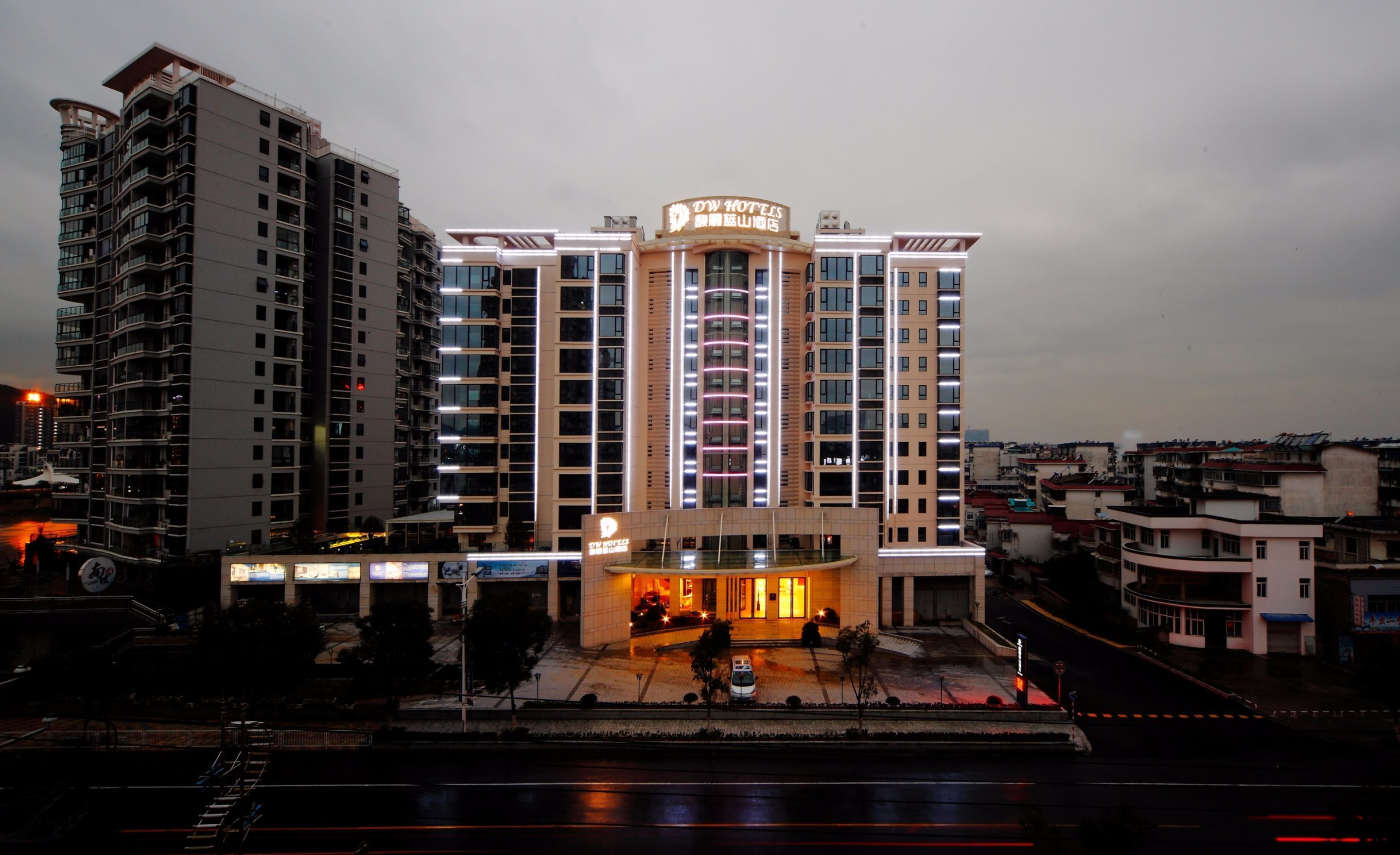 A multi-story hotel with a prominent sign at the top.