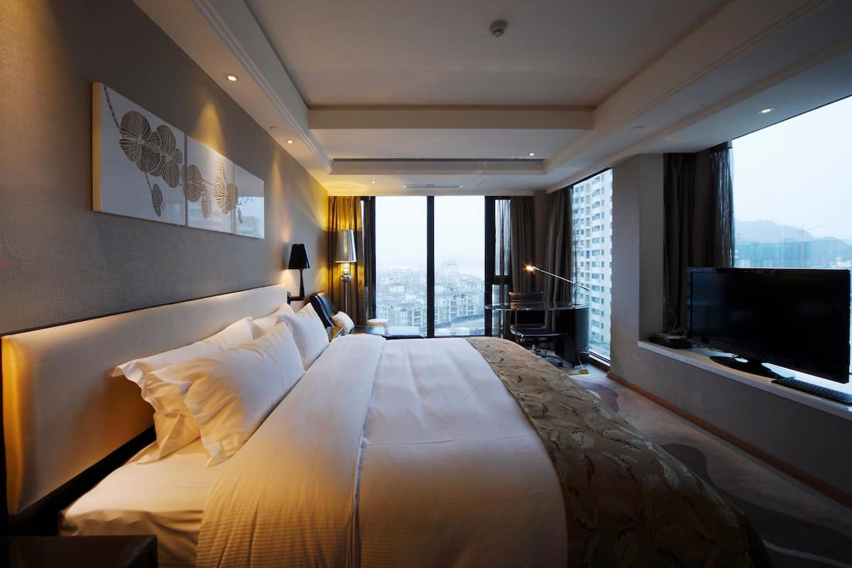 deluxe double room, river view | minibar, in-room safe, desk, laptop workspace