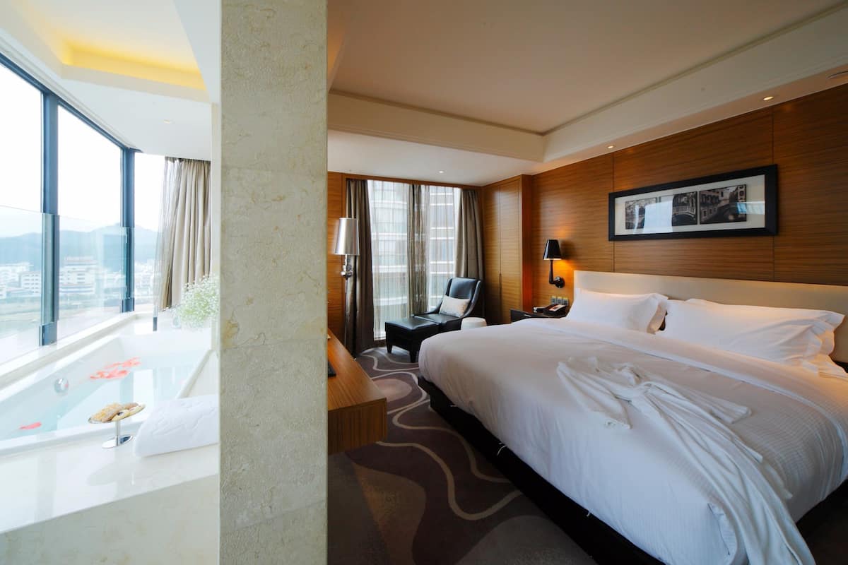 deluxe double room, river view | minibar, in-room safe, desk, laptop workspace