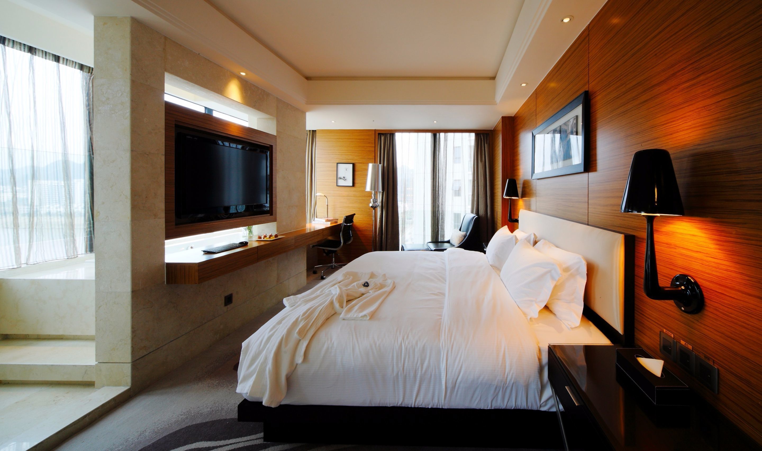 deluxe double room, river view | minibar, in-room safe, desk, laptop workspace