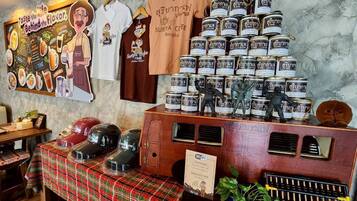 A restaurant interior with a wooden counter displaying food items, a menu board, and a Wi-Fi sign.